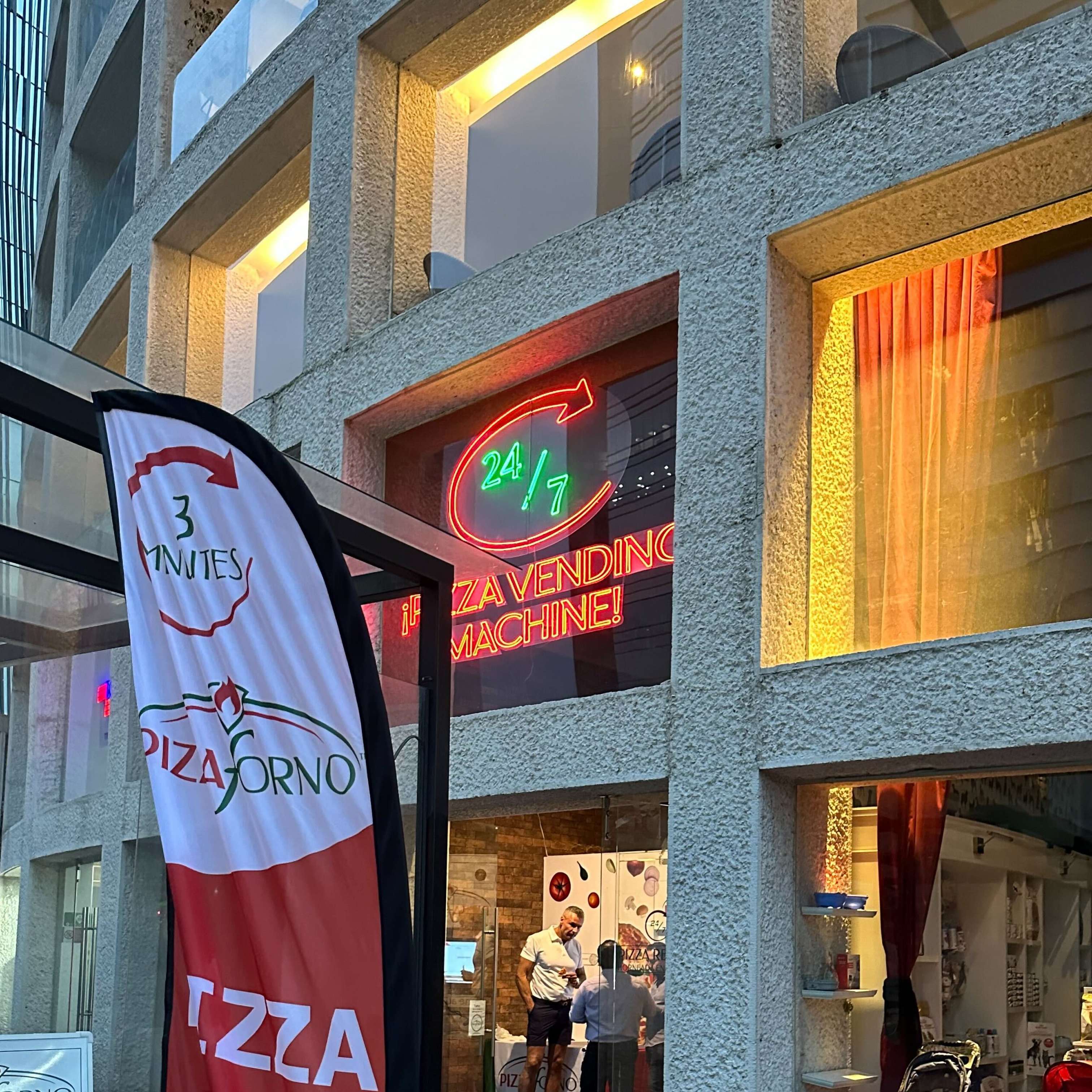 The PizzaForno flag banner outside the first Mexico location.
